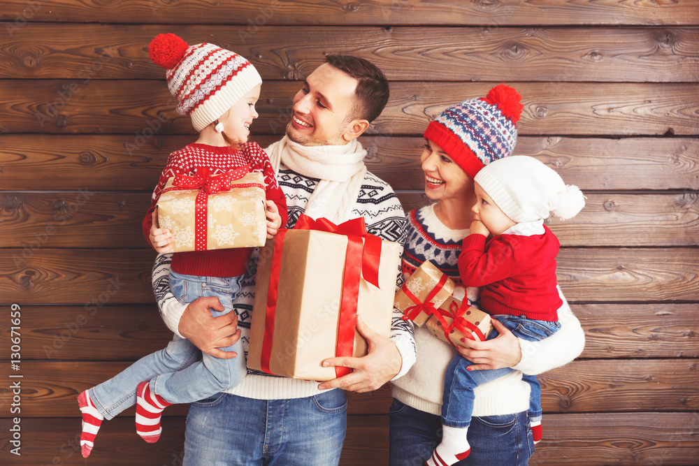 happy family mother, father and children with Christmas gifts on