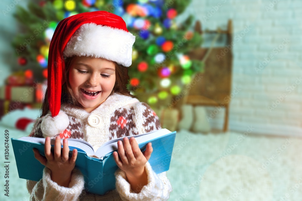 Surprised child opening book.