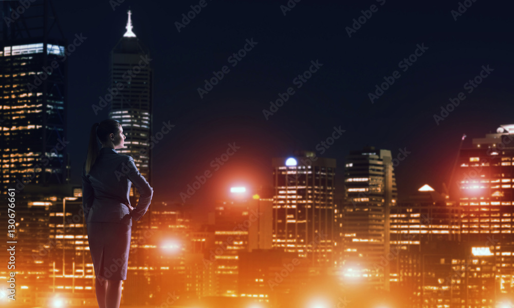 Woman looking at night city