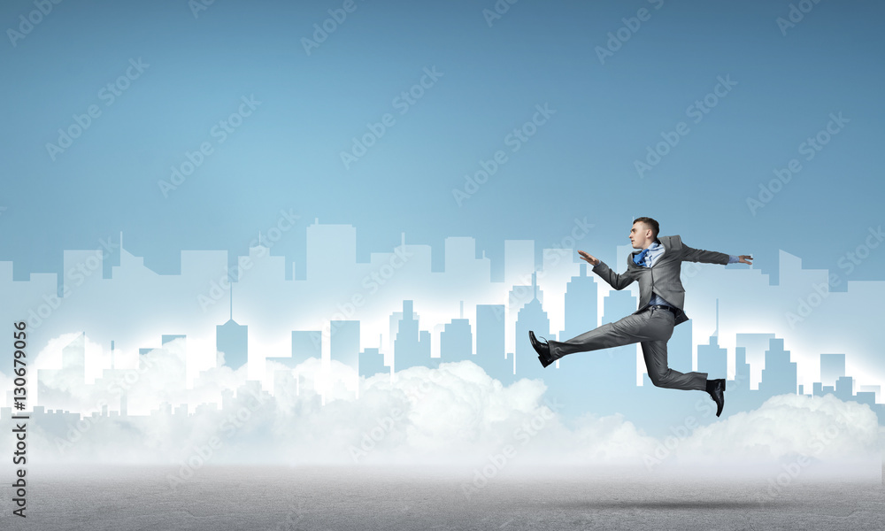 Businessman jumping high