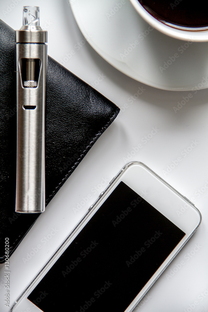 smartphone, electronic cigarette and mens accessories top view