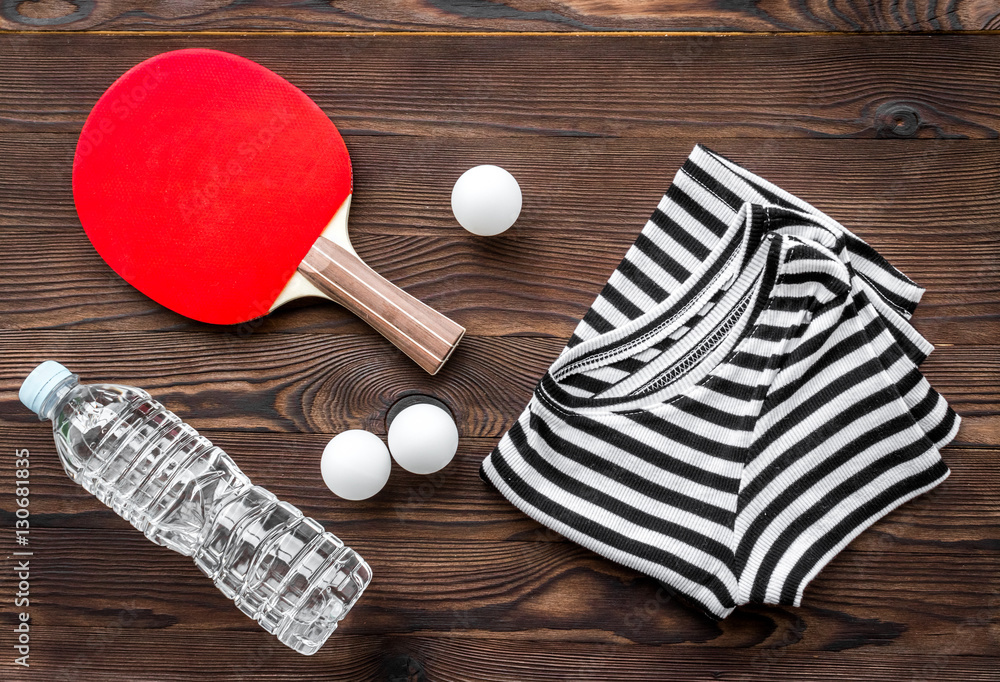 tennis racquet - fitness in the wooden background top view