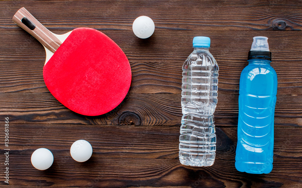 tennis racquet - fitness in the wooden background top view