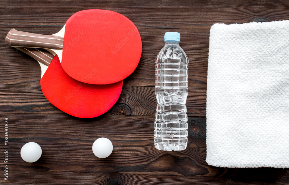 tennis racquet - fitness in the wooden background top view