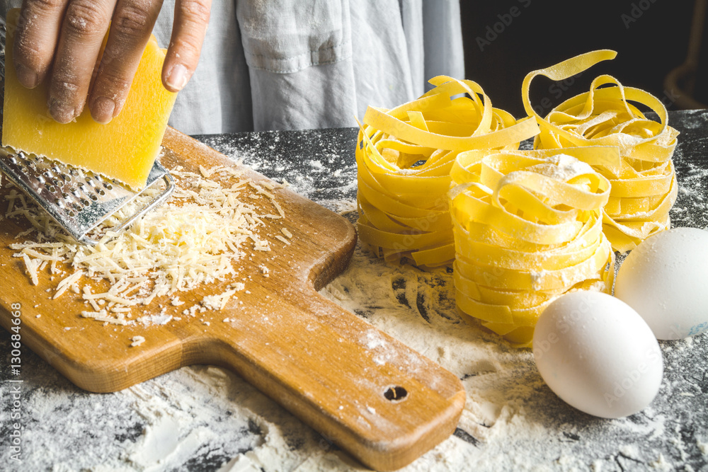 cooking pasta by chef in kitchen on dark background