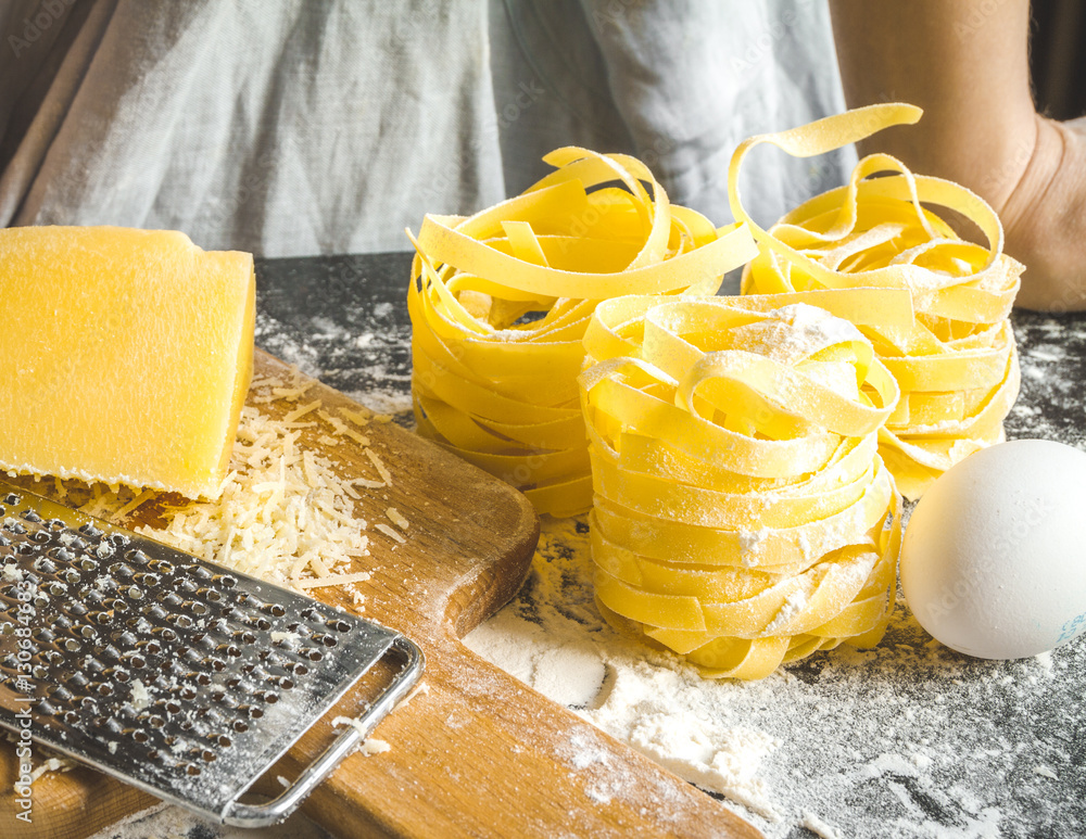 cooking pasta by chef in kitchen on dark background