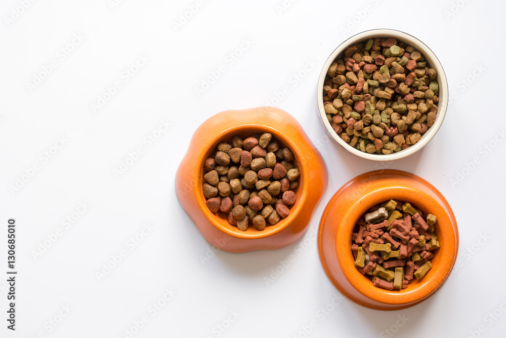 dry pet food in bowl on white background top view