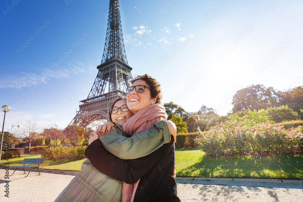 Happy meeting of friends hugging in Paris