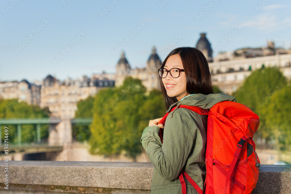 Young girl walking along bank of Seine River