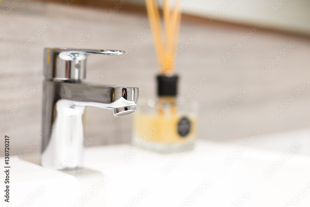 elegant silver tap on white sink