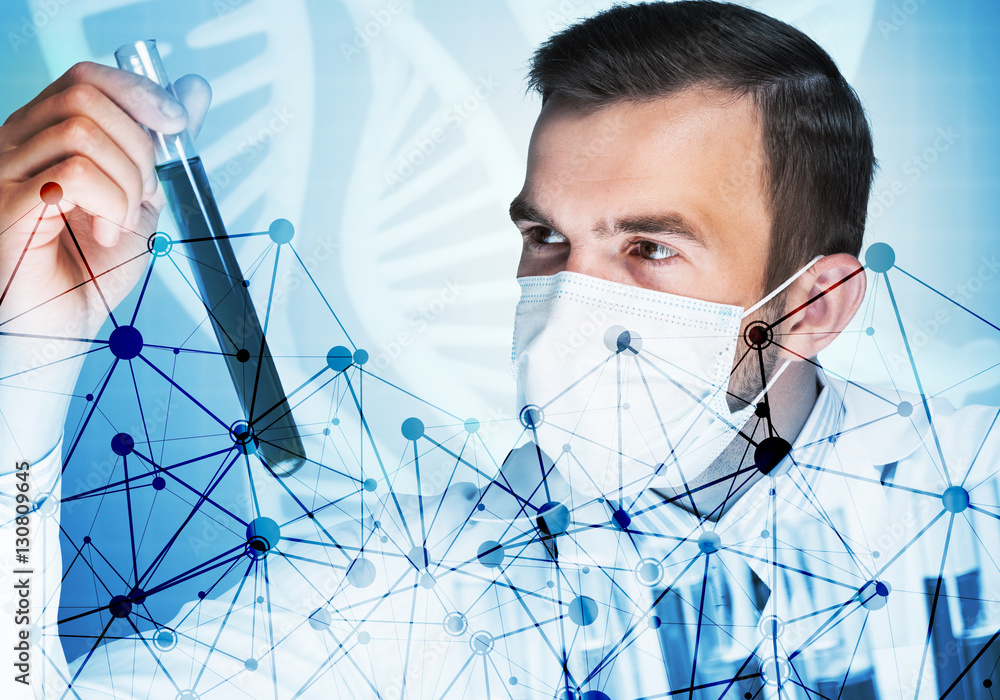 Portrait of concentrated male scientist working with reagents in laboratory