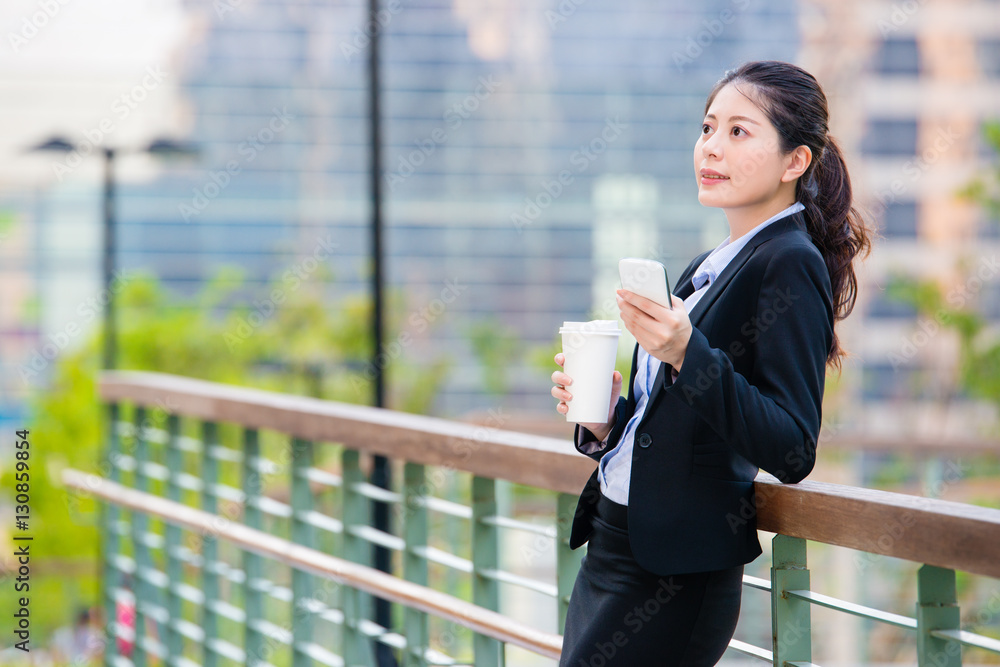 beautiful asian business woman drinking coffee use smart phone