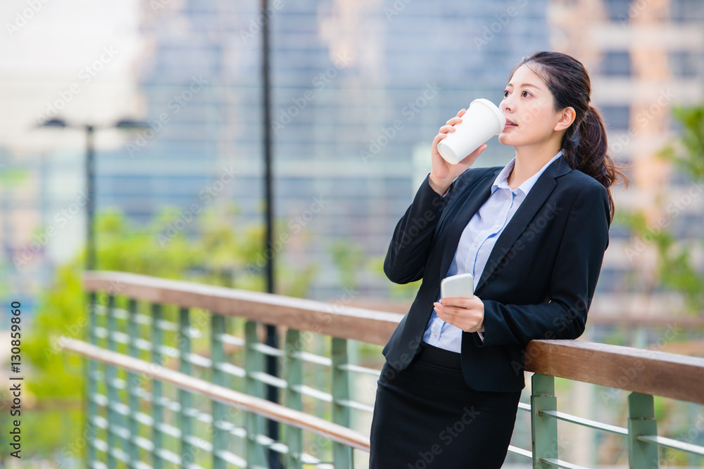 beautiful asian business woman drinking coffee use smart phone