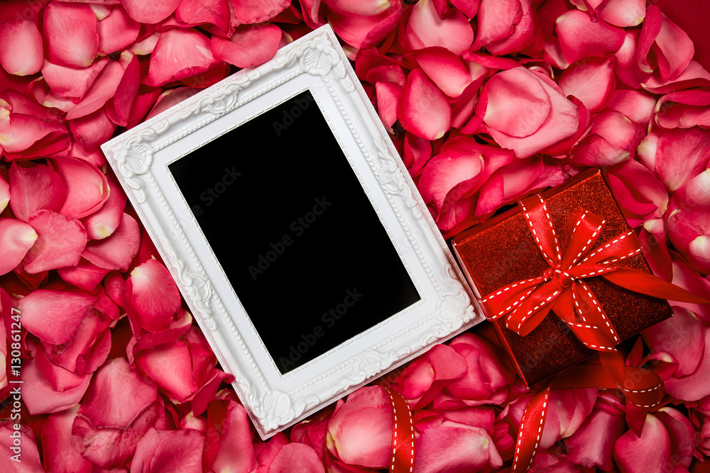 Empty photo frame with  sweet pink roses  petal and red gift box