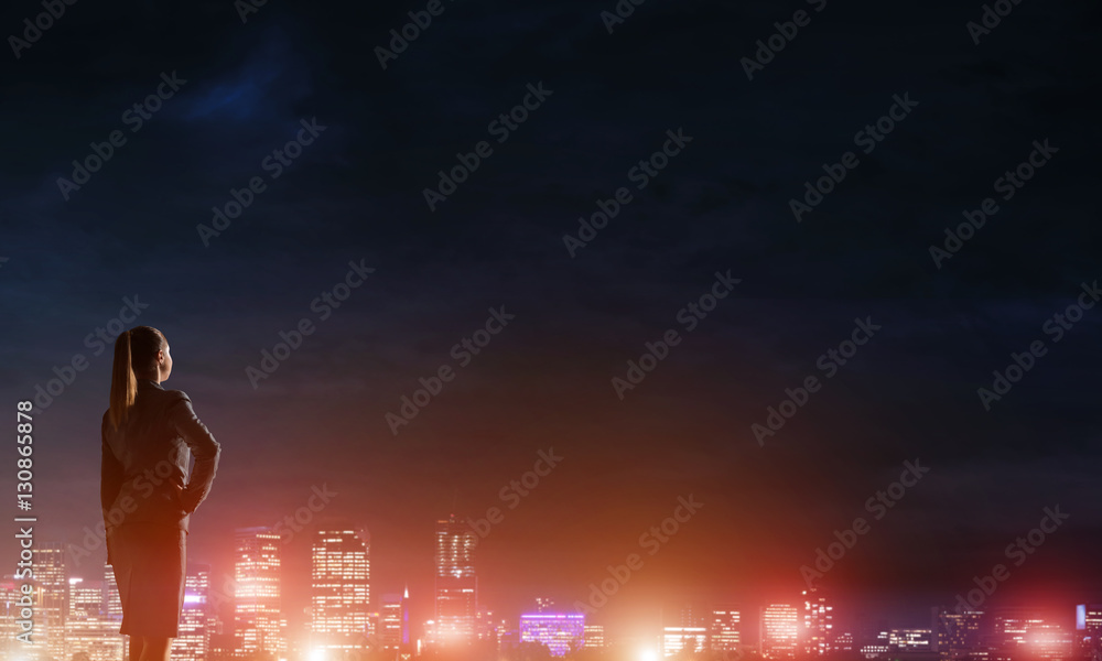 Woman looking at night city