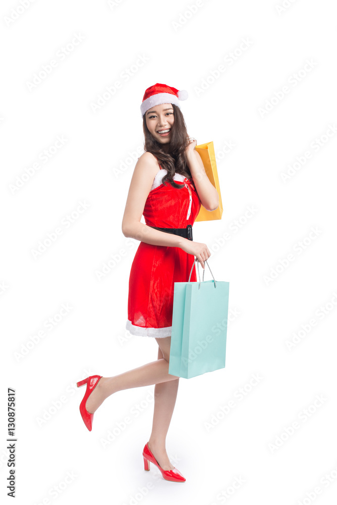 Full length portrait of a young smiling asian woman holding shop