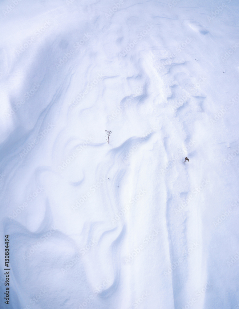 textured snow in the field or in the dunes outdoors in winter. Snow beautiful background and a small