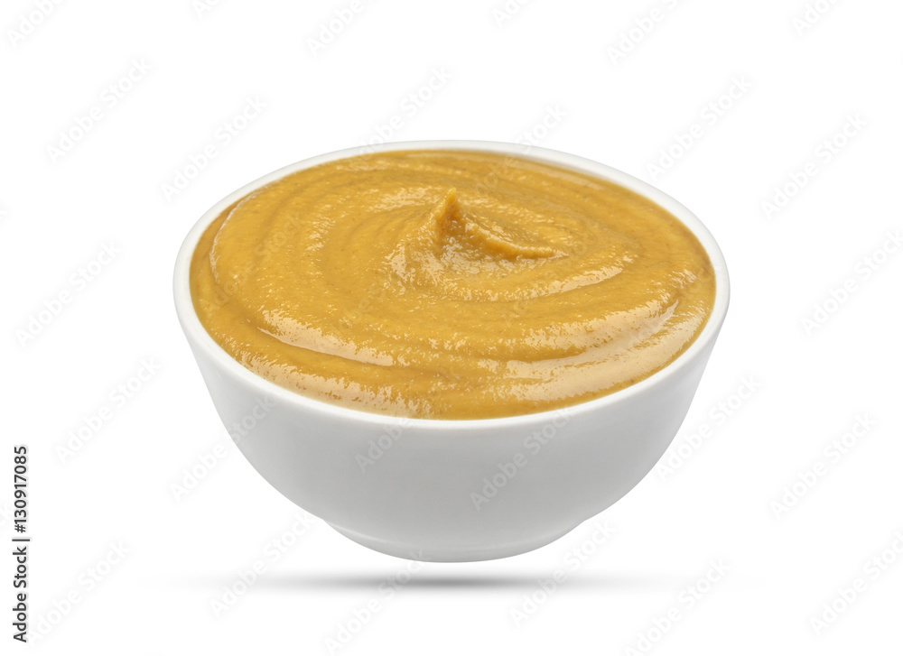 Mustard in bowl isolated on white background