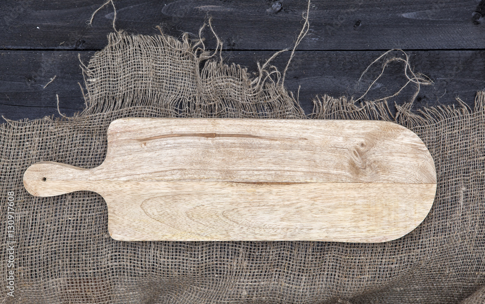 Empty chopping board on wooden table, cheese background concept, top view