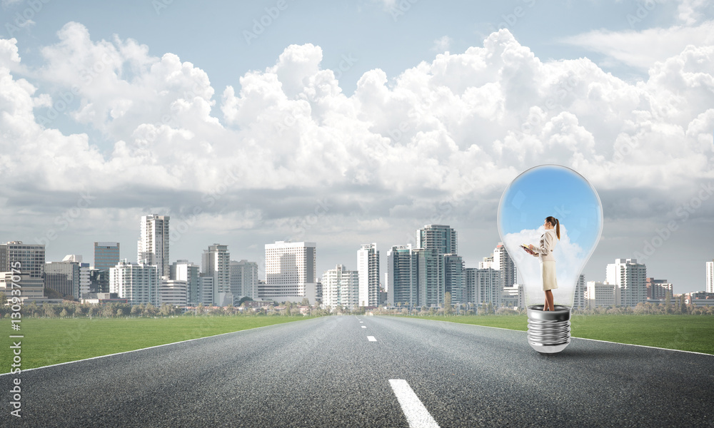 Businesswoman inside light bulb