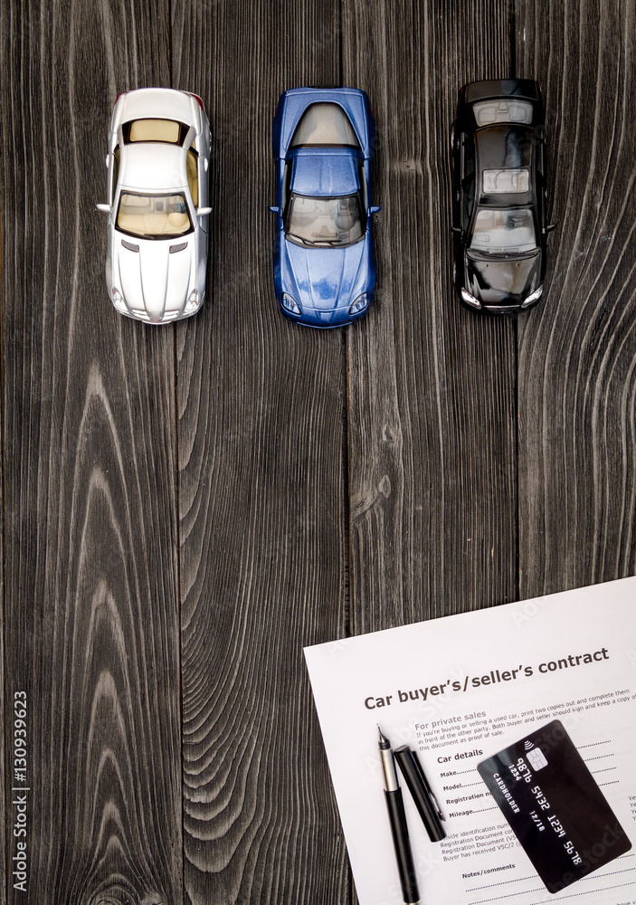 concept of buying car on dark wooden background top view