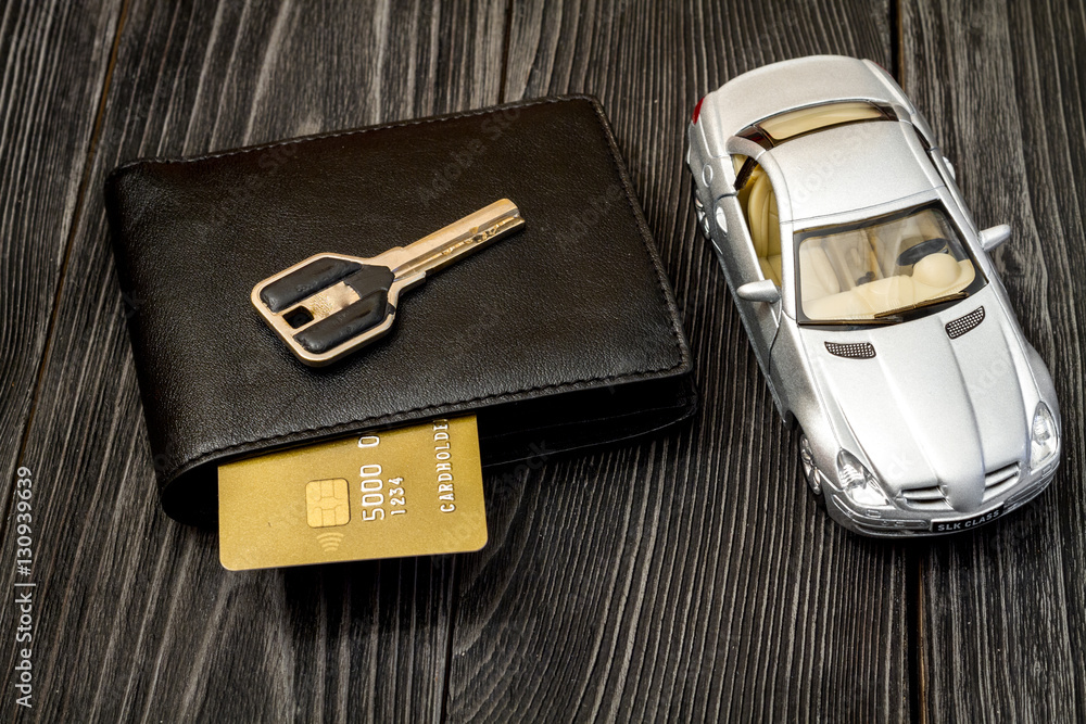 concept of buying car on dark wooden background