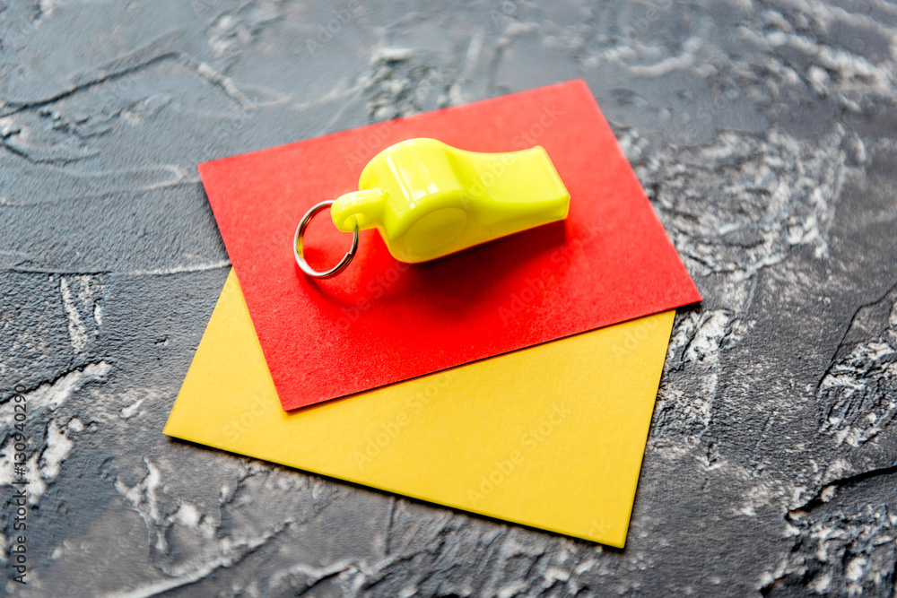 red and yellow cards on dark background close up