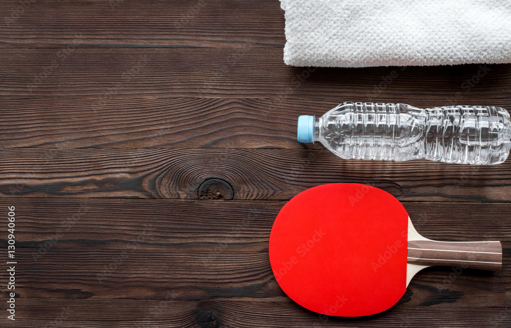 tennis racquet - fitness in the wooden background top view