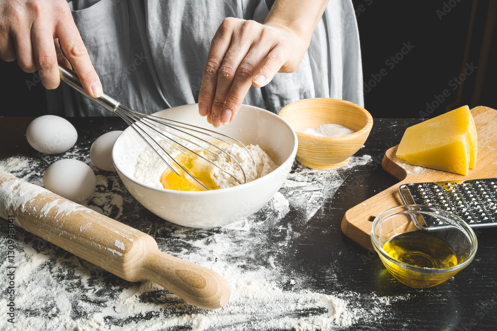 cooking pasta by chef in kitchen on dark background