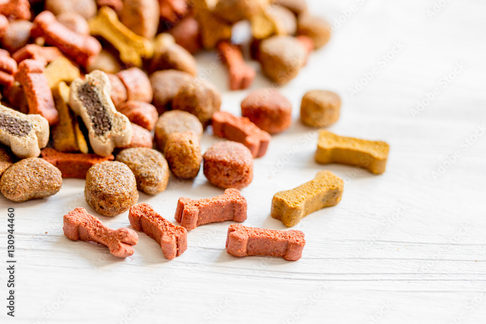 dry dog food in bulk on wooden background close up