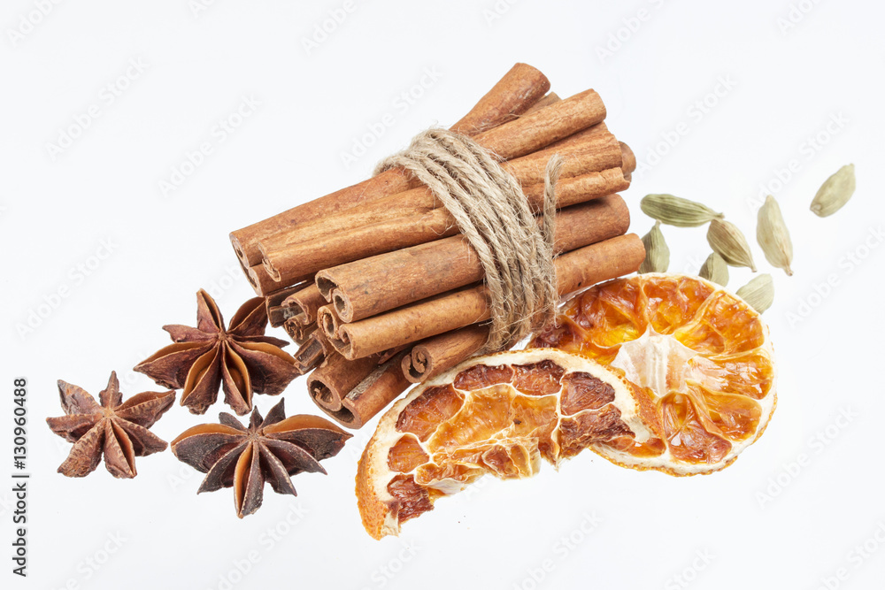 Dried orange, anise stars and cinnamon sticks isolated on white background