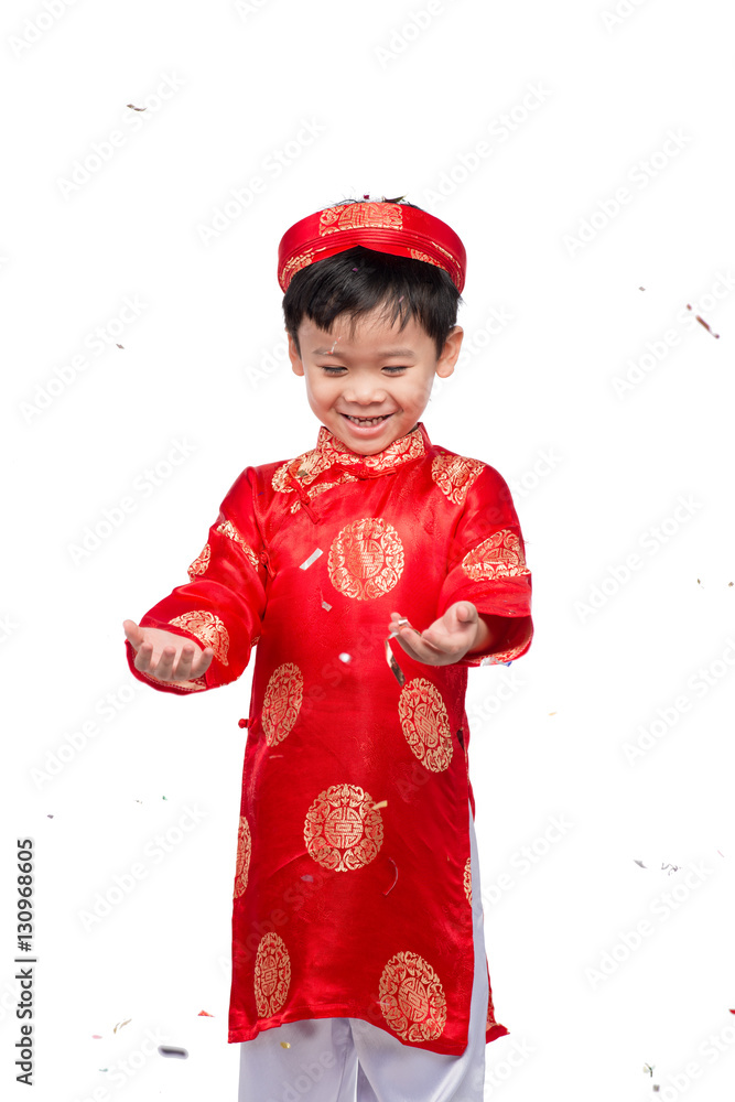 Happy Vietnamese boy in red Ao Dai celebrating New Year with con