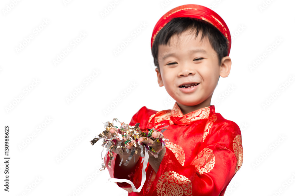 Happy Vietnamese boy in red Ao Dai celebrating New Year with con