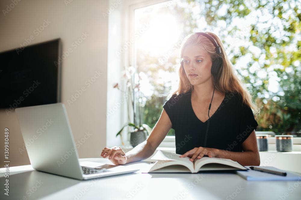 Young female student studying at home