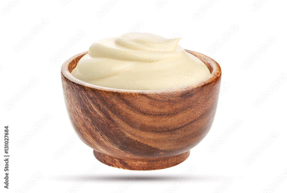 Homemade mayonnaise sauce in wooden bowl isolated on white background with clipping path