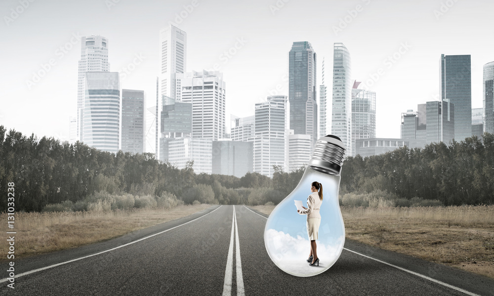 Businesswoman inside light bulb