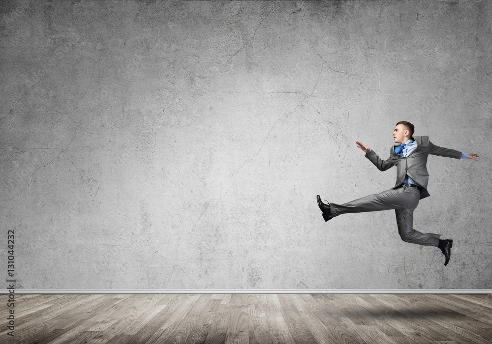 Businessman jumping high