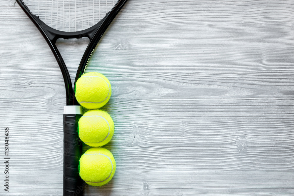 tennis racket on wooden background top view