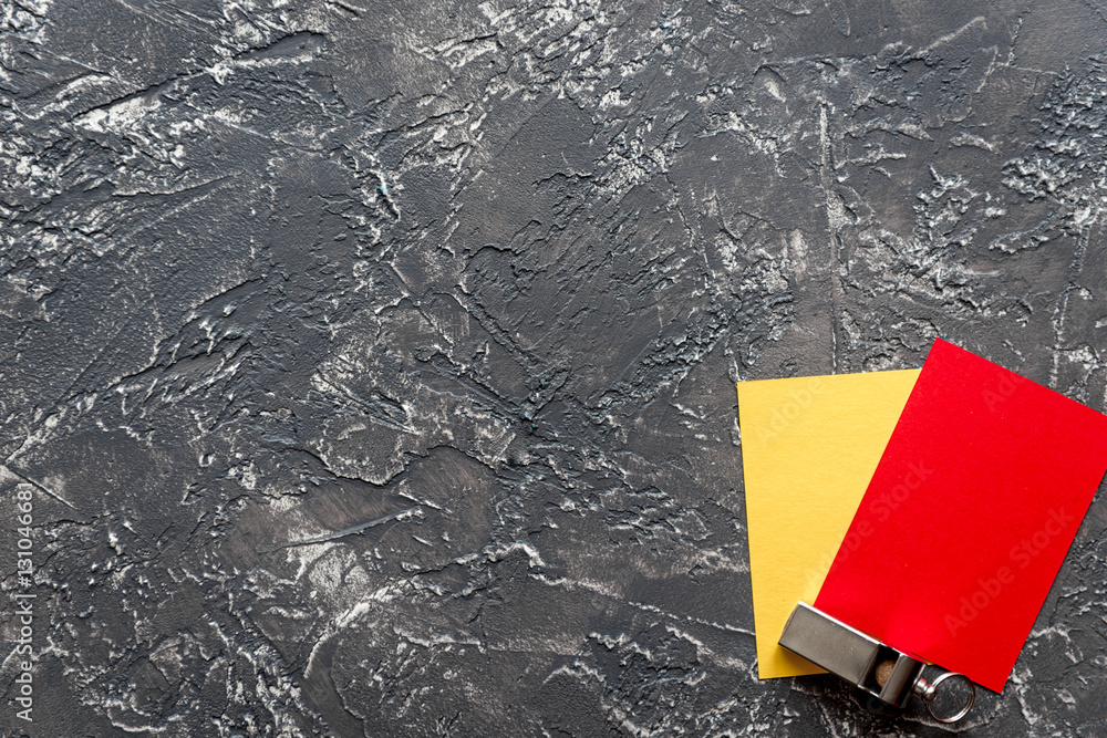 red and yellow cards on dark background top view