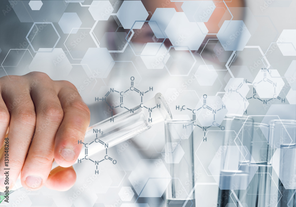 Portrait of concentrated male scientist working with reagents in laboratory