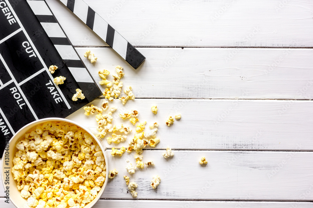 watching movie with popcorn on wooden background top view