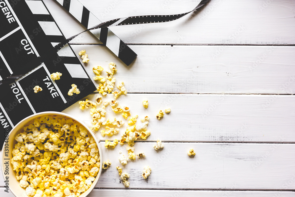 watching movie with popcorn on wooden background top view