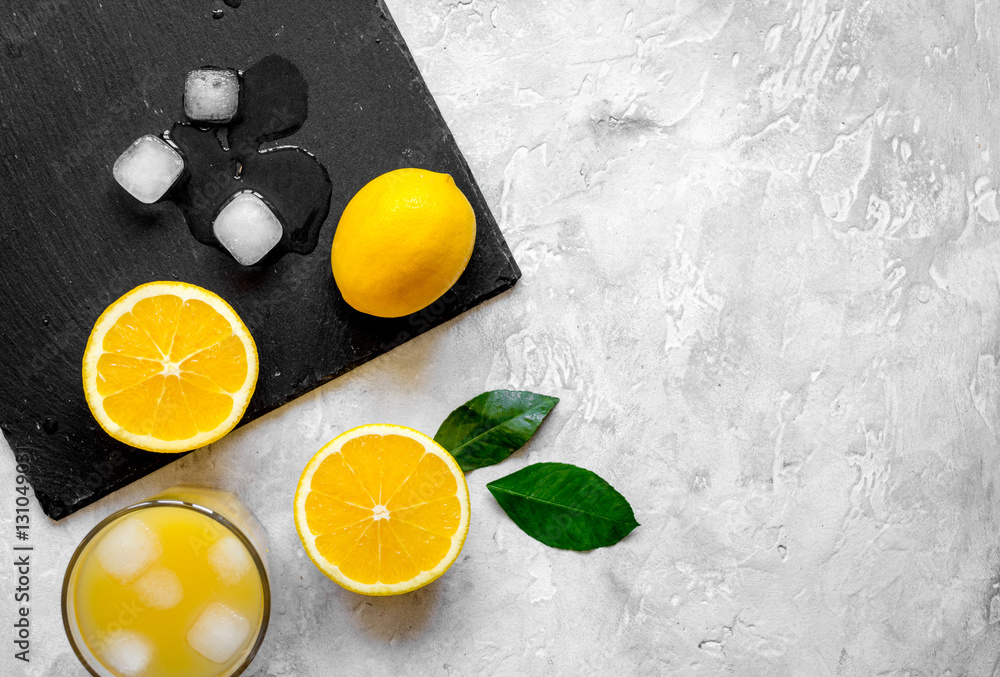 freshly squeezed orange juice on concrete background top view