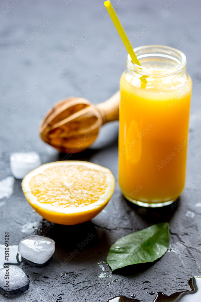 freshly squeezed orange juice on dark background