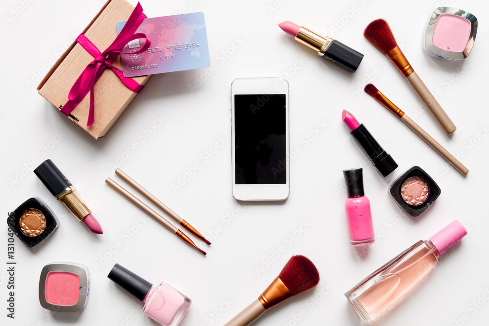 concept online shopping cosmetics on white background top view