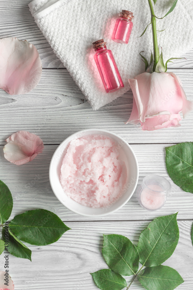 organic cosmetic with rose oil on wooden background top view