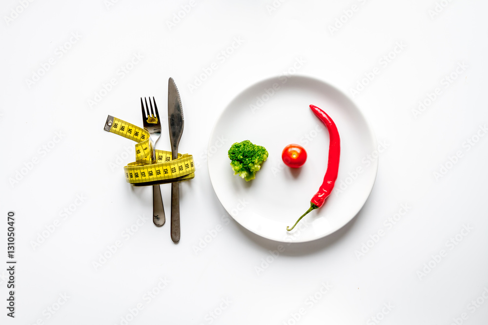 concept slimming diet fresh vegetables on white background top view