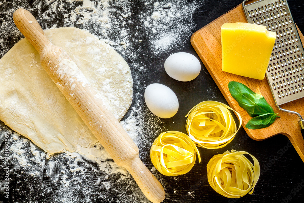 cooking process of pasta on dark background top view