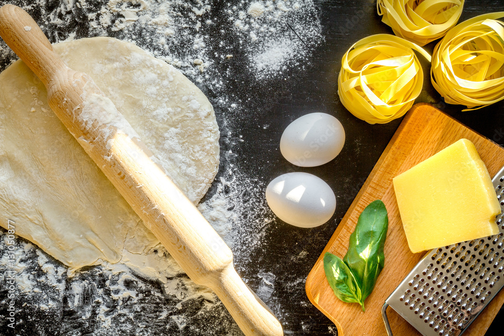 cooking process of pasta on dark background top view