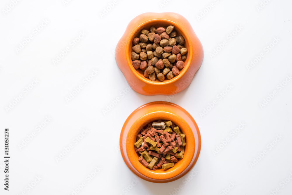 dry pet food in bowl on white background top view